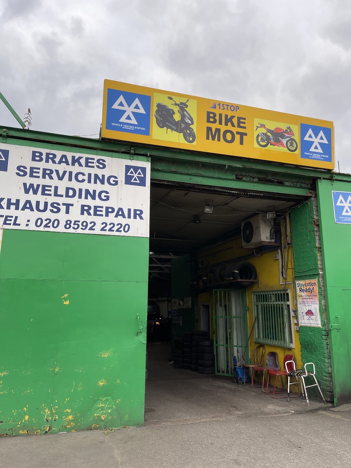 Mechanic working underneath a car on the ramp at 1 Stop MOT & repairs ltd